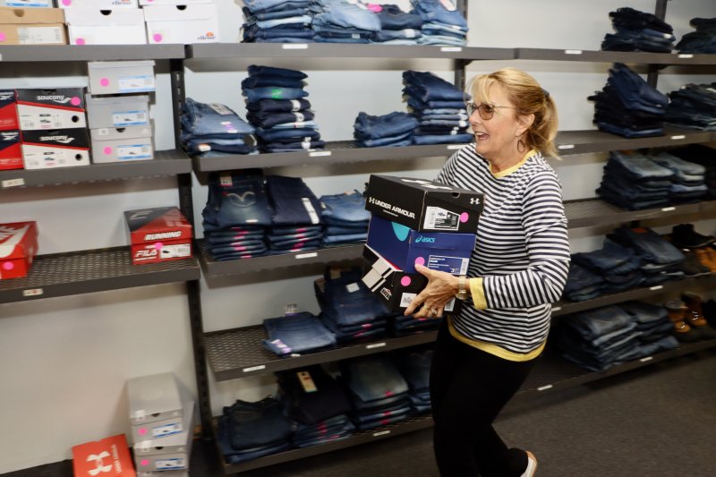 Debbie Faust is one of the volunteers helping get the shoes on the shelves.